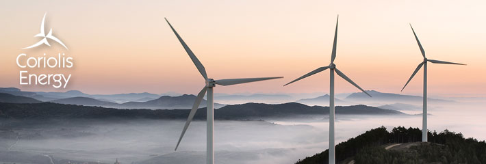 Image: Three wind turbines on a mountain top at dawn